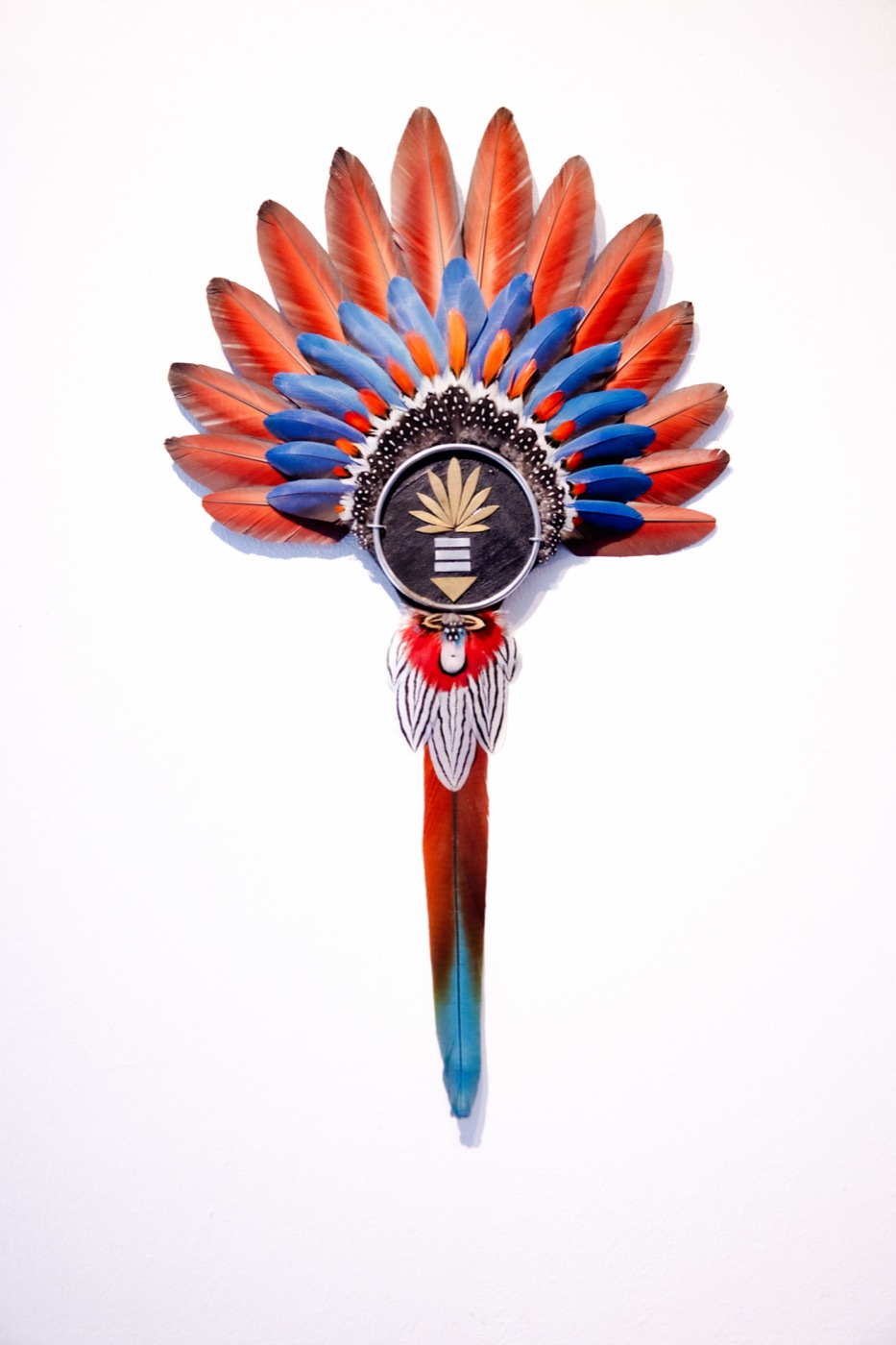 Crimson Crescents, a featherwork sculpture with twin curving red and blue arcs